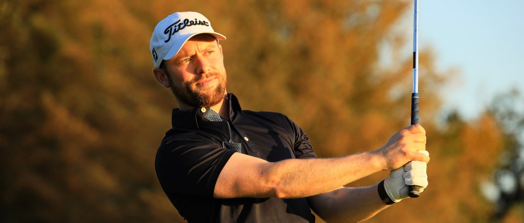 Gary Shaw Golf coaching in London, swinging an iron into the sun. LGBT+ gay and lesbian golf coaching and events