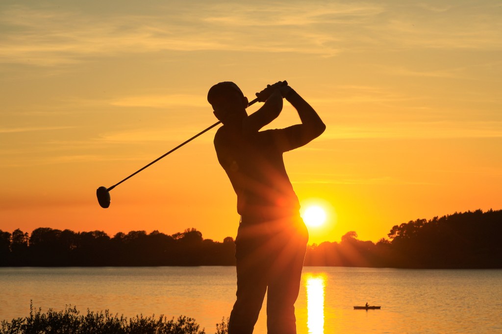 Gary Shaw PGA golf Professional swinging a driver into the sunset